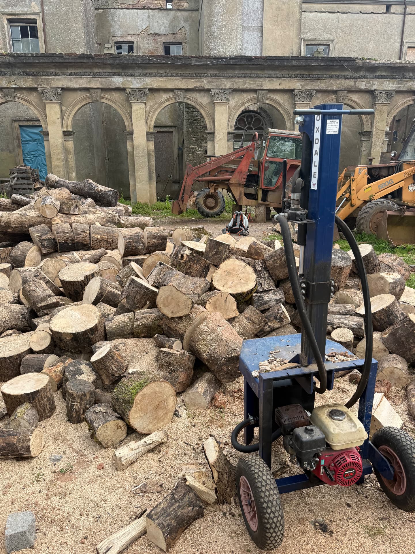 Oxdales hydraulic log splitter and cut logs ready for firewood